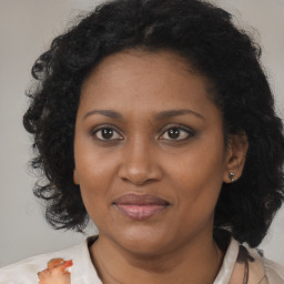 Joyful black adult female with medium  brown hair and brown eyes