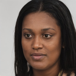 Joyful black young-adult female with long  brown hair and brown eyes