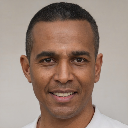 Joyful latino adult male with short  black hair and brown eyes