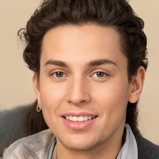 Joyful white young-adult male with medium  brown hair and brown eyes