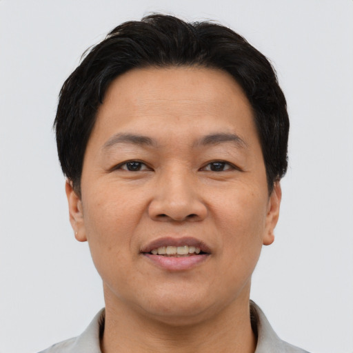 Joyful asian adult male with short  brown hair and brown eyes