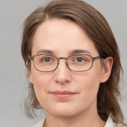 Joyful white adult female with medium  brown hair and blue eyes