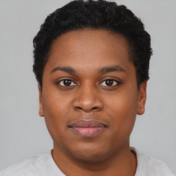 Joyful black young-adult male with short  brown hair and brown eyes