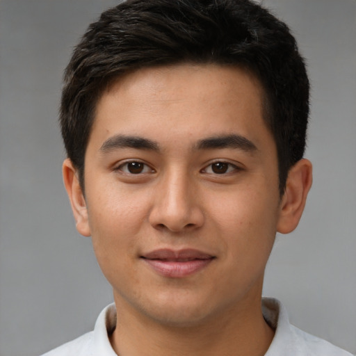 Joyful latino young-adult male with short  brown hair and brown eyes