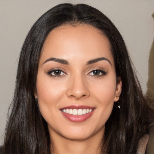 Joyful white young-adult female with long  brown hair and brown eyes