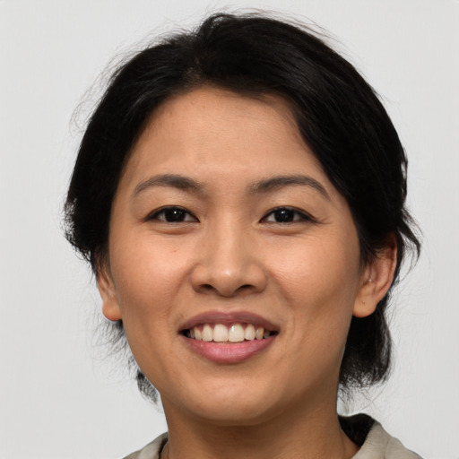 Joyful asian young-adult female with medium  black hair and brown eyes