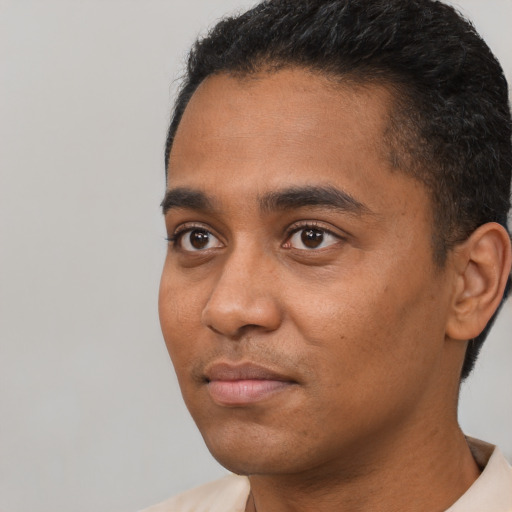 Neutral black young-adult male with short  black hair and brown eyes
