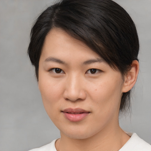 Joyful asian young-adult female with medium  brown hair and brown eyes