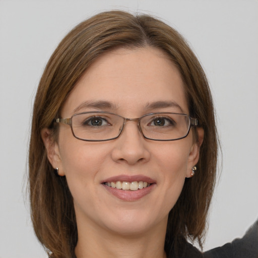 Joyful white young-adult female with medium  brown hair and grey eyes