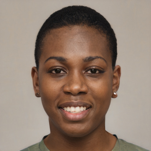 Joyful black young-adult female with short  black hair and brown eyes