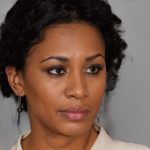 Neutral black young-adult female with medium  brown hair and brown eyes