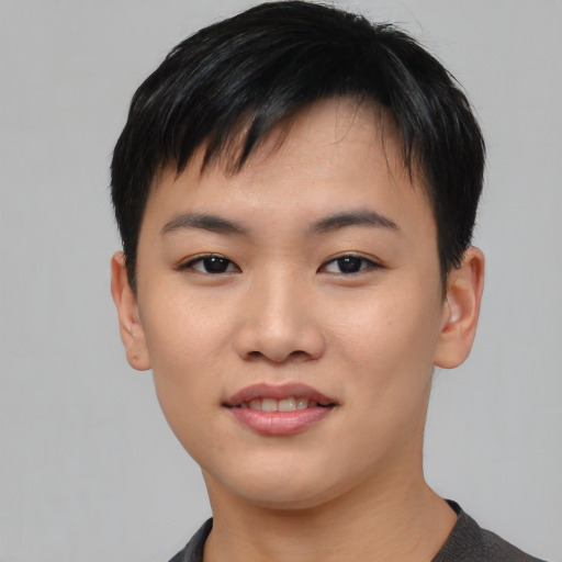 Joyful asian young-adult male with short  black hair and brown eyes
