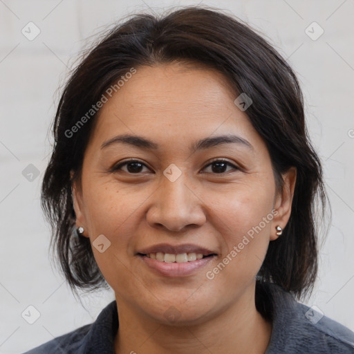 Joyful latino adult female with medium  brown hair and brown eyes