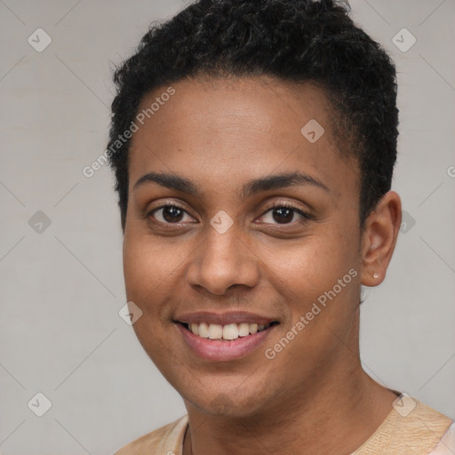 Joyful black young-adult female with short  black hair and brown eyes