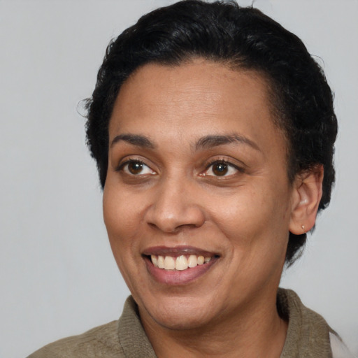 Joyful latino adult female with short  brown hair and brown eyes