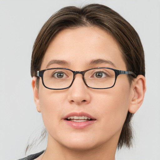 Joyful white young-adult female with medium  brown hair and brown eyes