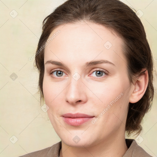 Joyful white young-adult female with medium  brown hair and green eyes