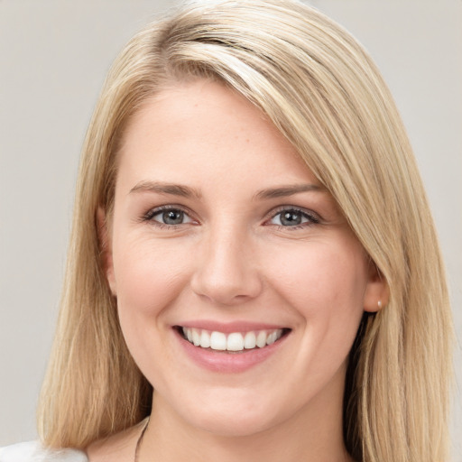 Joyful white young-adult female with medium  brown hair and blue eyes