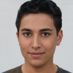 Joyful latino young-adult male with short  brown hair and brown eyes