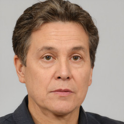 Joyful white middle-aged male with short  brown hair and brown eyes