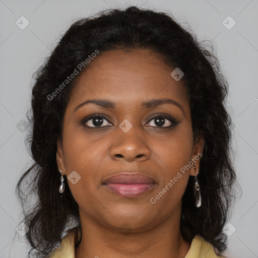 Joyful black young-adult female with long  brown hair and brown eyes