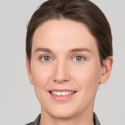 Joyful white young-adult female with short  brown hair and grey eyes