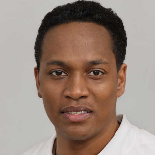 Joyful black young-adult male with short  black hair and brown eyes