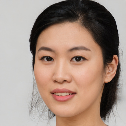 Joyful asian young-adult female with medium  brown hair and brown eyes