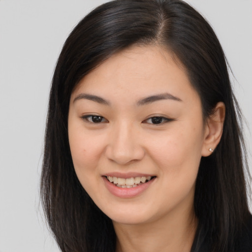 Joyful asian young-adult female with long  brown hair and brown eyes