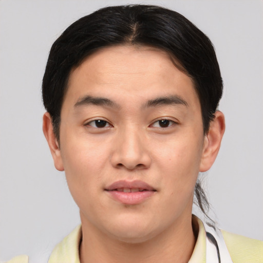 Joyful asian young-adult male with short  brown hair and brown eyes
