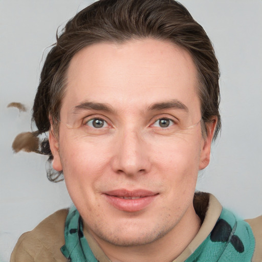 Joyful white adult male with medium  brown hair and grey eyes