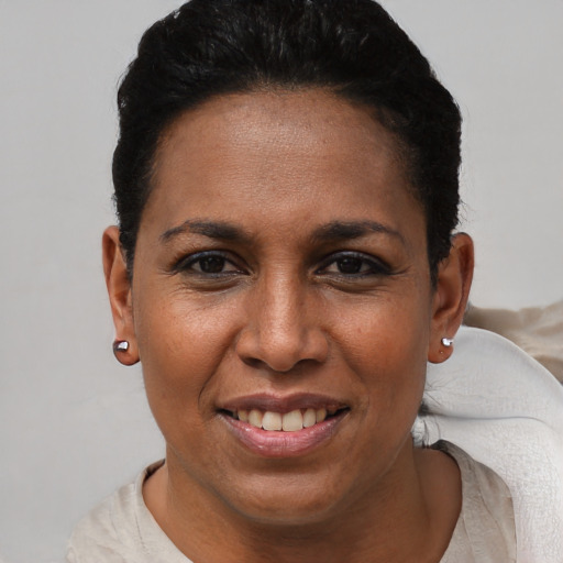 Joyful black adult female with short  black hair and brown eyes