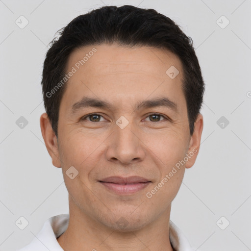 Joyful white adult male with short  black hair and brown eyes