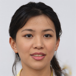 Joyful asian young-adult female with medium  brown hair and brown eyes