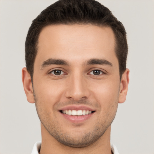 Joyful white young-adult male with short  brown hair and brown eyes