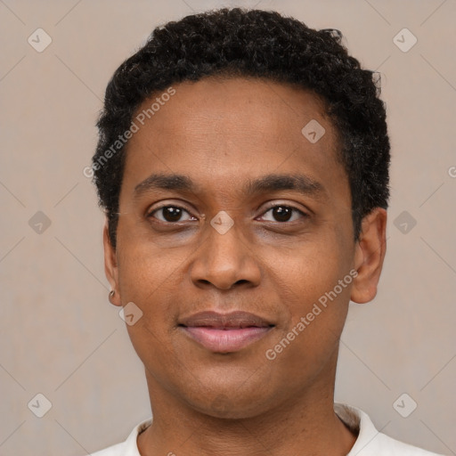 Joyful black young-adult male with short  black hair and brown eyes