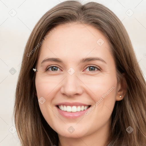 Joyful white young-adult female with long  brown hair and brown eyes