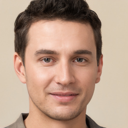 Joyful white young-adult male with short  brown hair and brown eyes