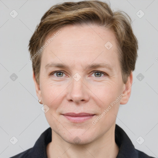 Joyful white adult female with short  brown hair and grey eyes