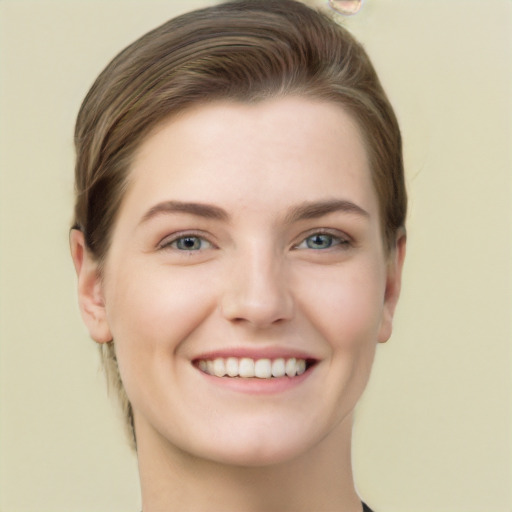 Joyful white young-adult female with long  brown hair and grey eyes