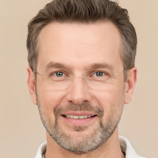 Joyful white adult male with short  brown hair and grey eyes