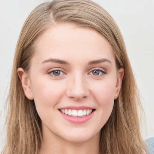 Joyful white young-adult female with long  brown hair and blue eyes