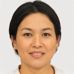 Joyful asian adult female with medium  brown hair and brown eyes