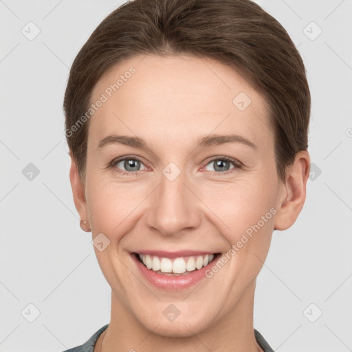 Joyful white young-adult female with short  brown hair and grey eyes