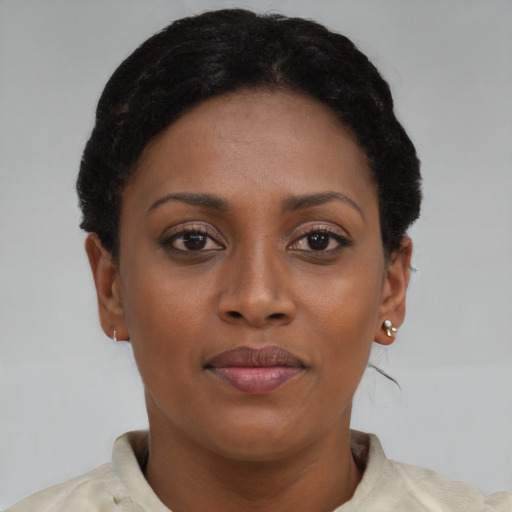 Joyful latino young-adult female with short  brown hair and brown eyes