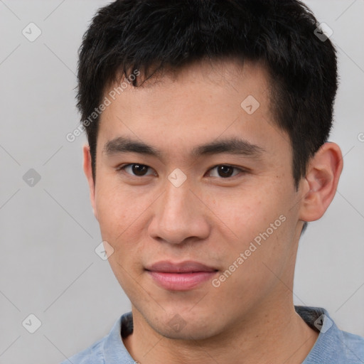 Joyful asian young-adult male with short  black hair and brown eyes