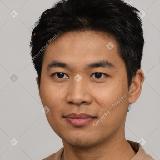 Joyful asian young-adult male with short  black hair and brown eyes