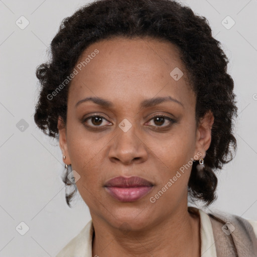 Joyful black adult female with long  brown hair and brown eyes