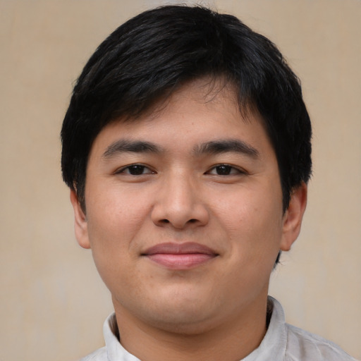 Joyful asian young-adult male with short  black hair and brown eyes