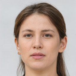 Joyful white young-adult female with long  brown hair and grey eyes